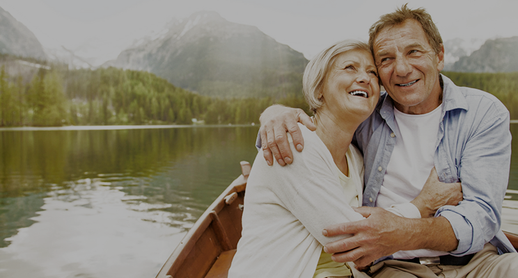 older couple embracing in a boat on a lake