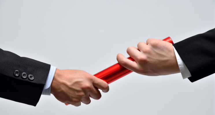 men passing red baton