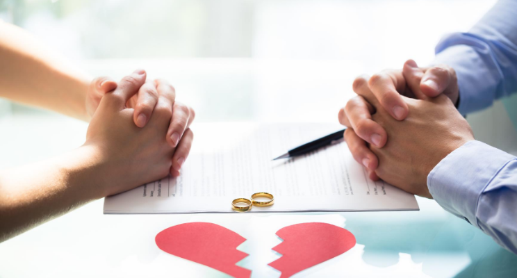 broken heart with two people with rings on tabel