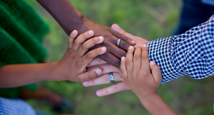 group of people with hands on each other