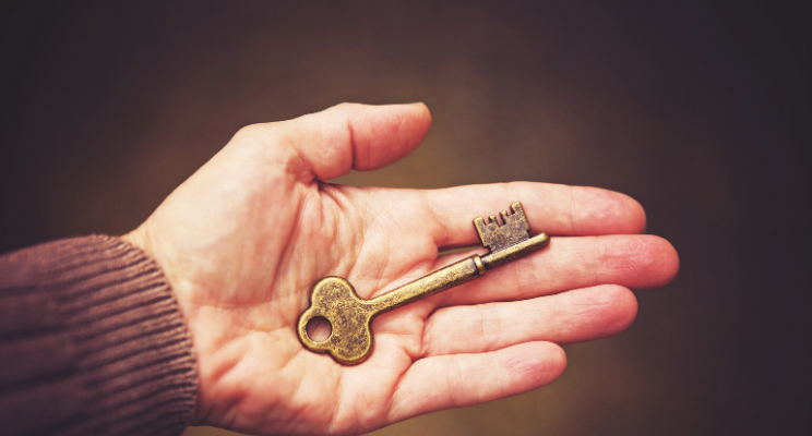 person holding key