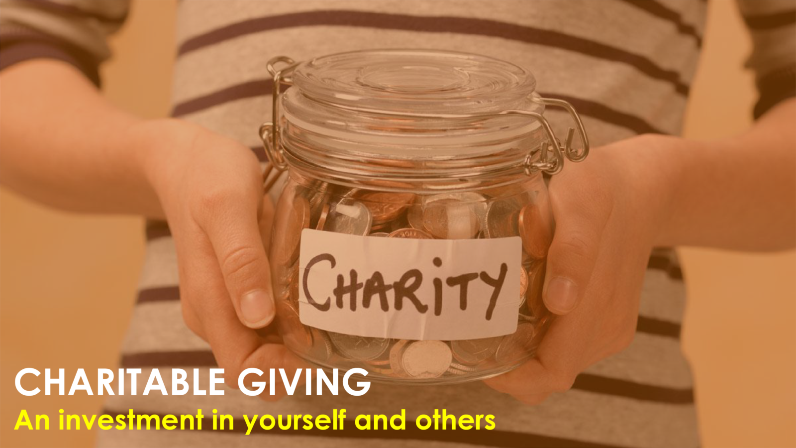 person holding jar with charity written